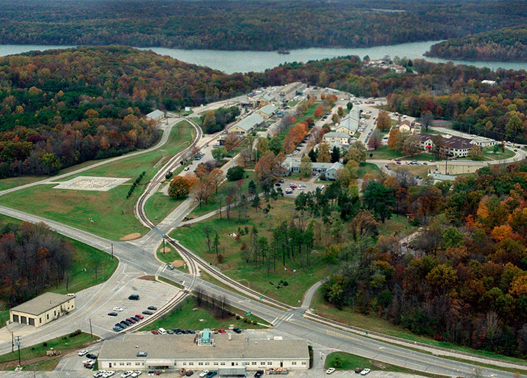 Aerial photograph of the downtown area of the Navy's Crane installation in Indiana, with buildings and roads among wooded terrain