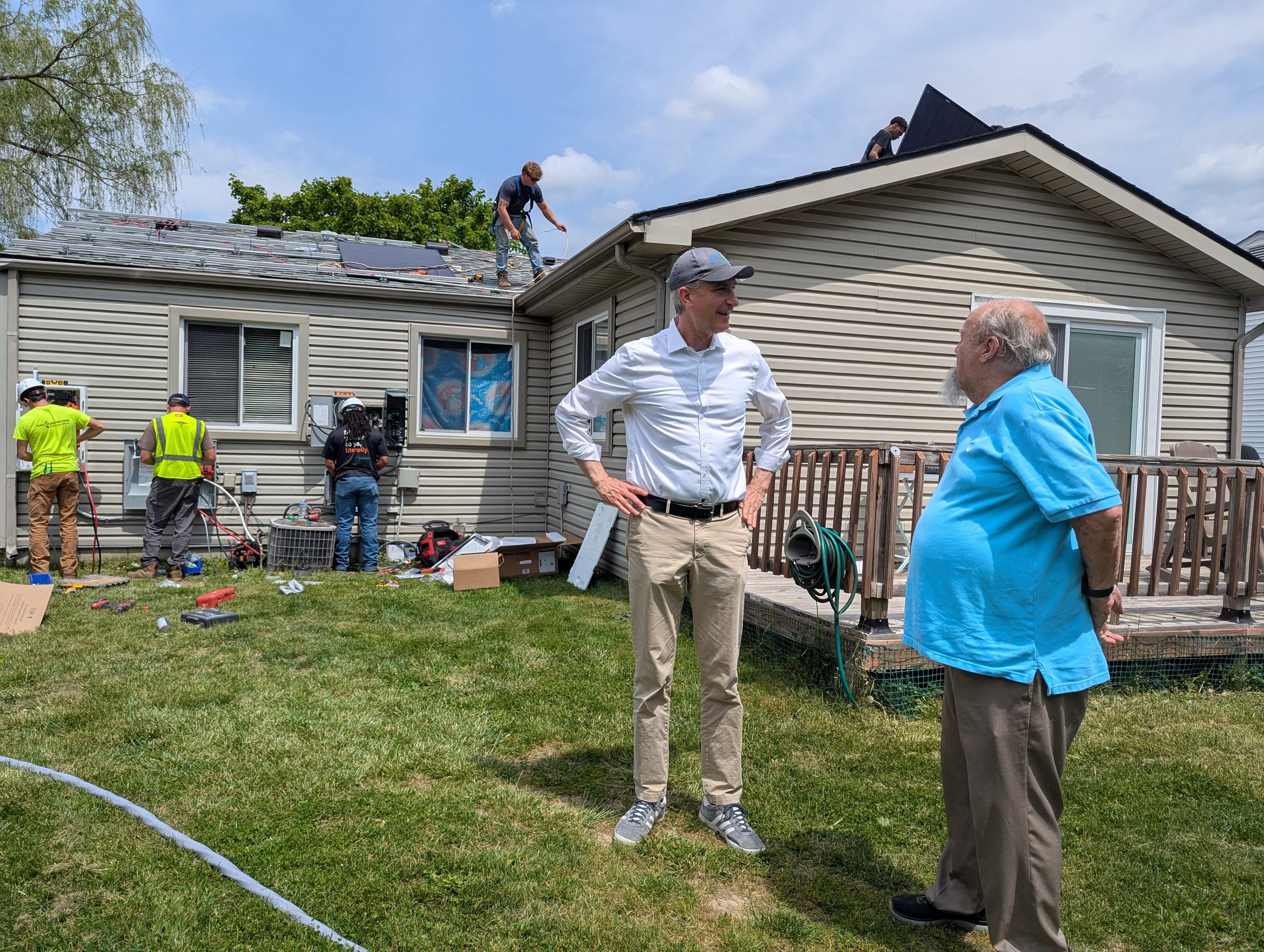 Ann Arbor's first Sustainable Energy Utility solar installation on a Hemlock Drive home in the Bryant neighborhood, with Mayor Christopher Taylor and resident Bruce Schauer