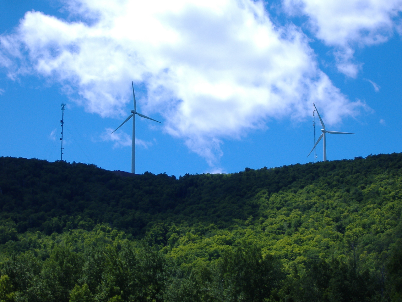 Wind turbines of the Mars Hill Wind Farm above a forested ridgeline in Aroostook County, Maine