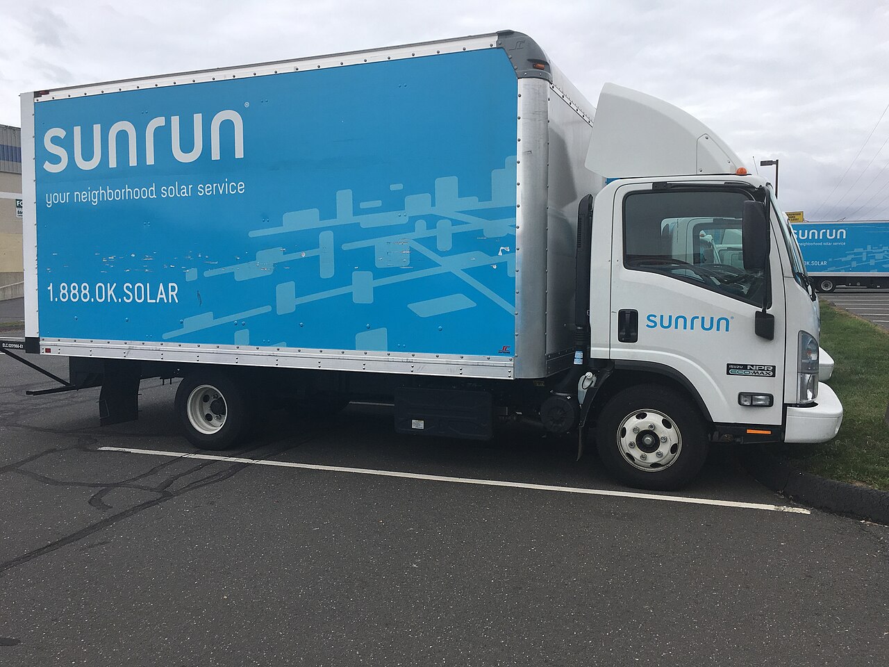 A Sunrun-branded box truck used for residential solar installations, parked in a lot