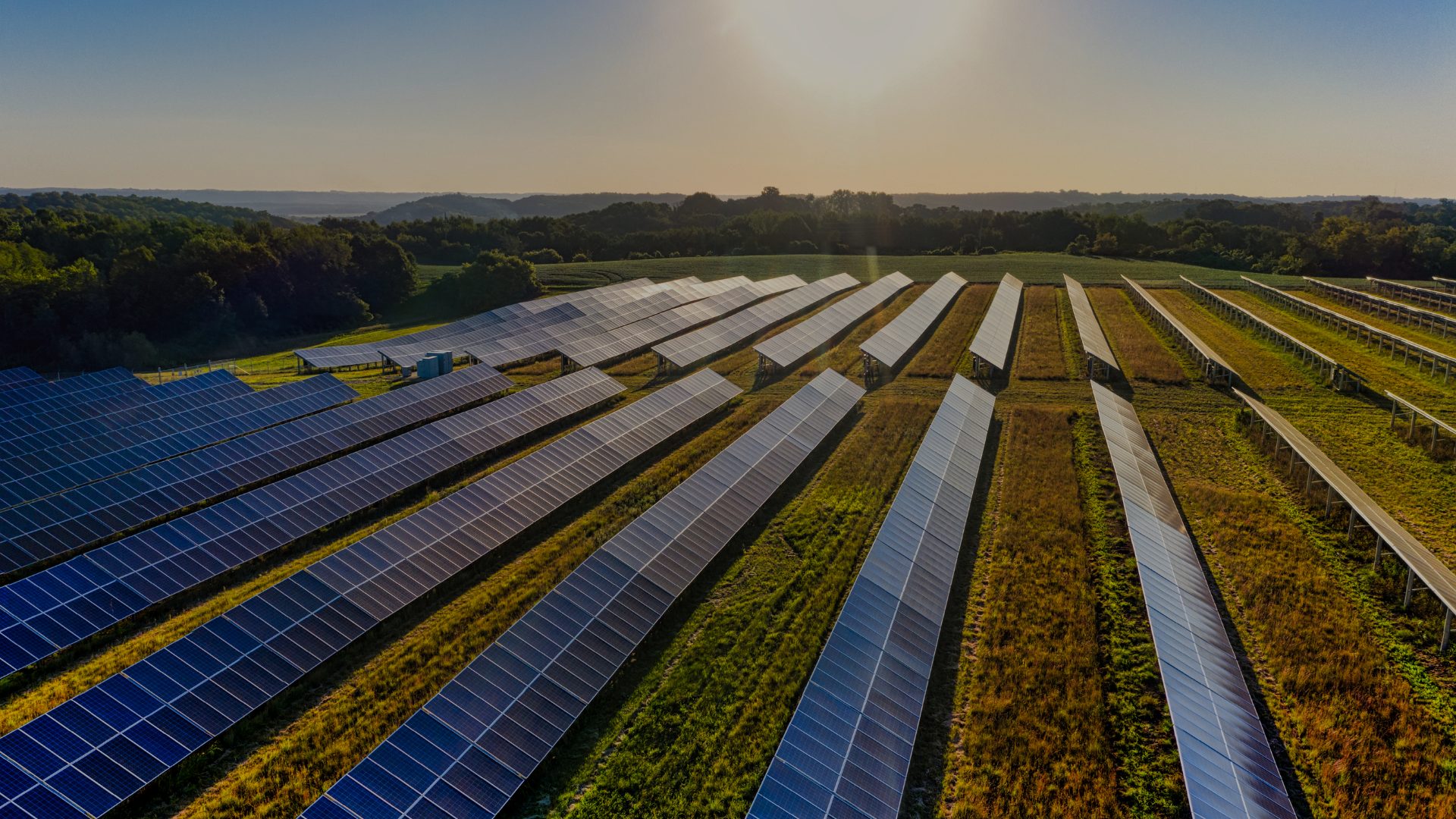 Aerial view of rows of solar panels on rolling farmland at sunset, the image MN8 Energy distributed with its September 2, 2026 announcement